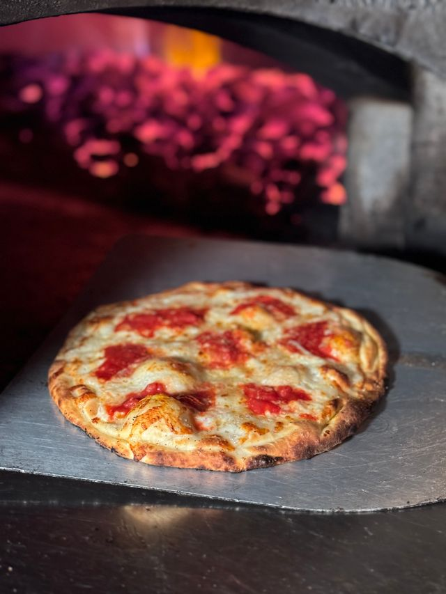  Pizza dough being coal fired at Anthony’s. 
