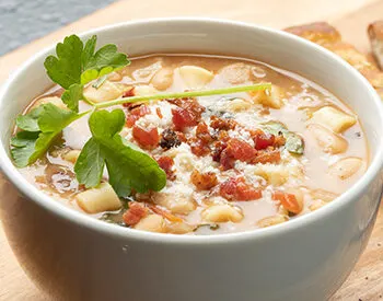 Pasta e fagioli soup with beans, pancetta, parmesan, and parsley.