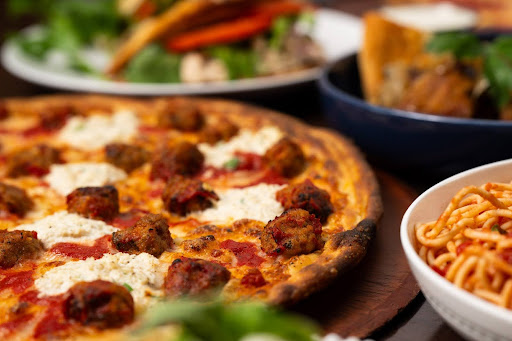 Coal-fired pizza with blistered crust and bubbling cheese from Anthony’s Coal Fired Pizza and Wings.