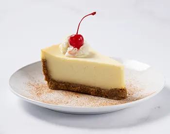 Close-up of NY Style Cheesecake from Anthony’s, with a rich and creamy texture.