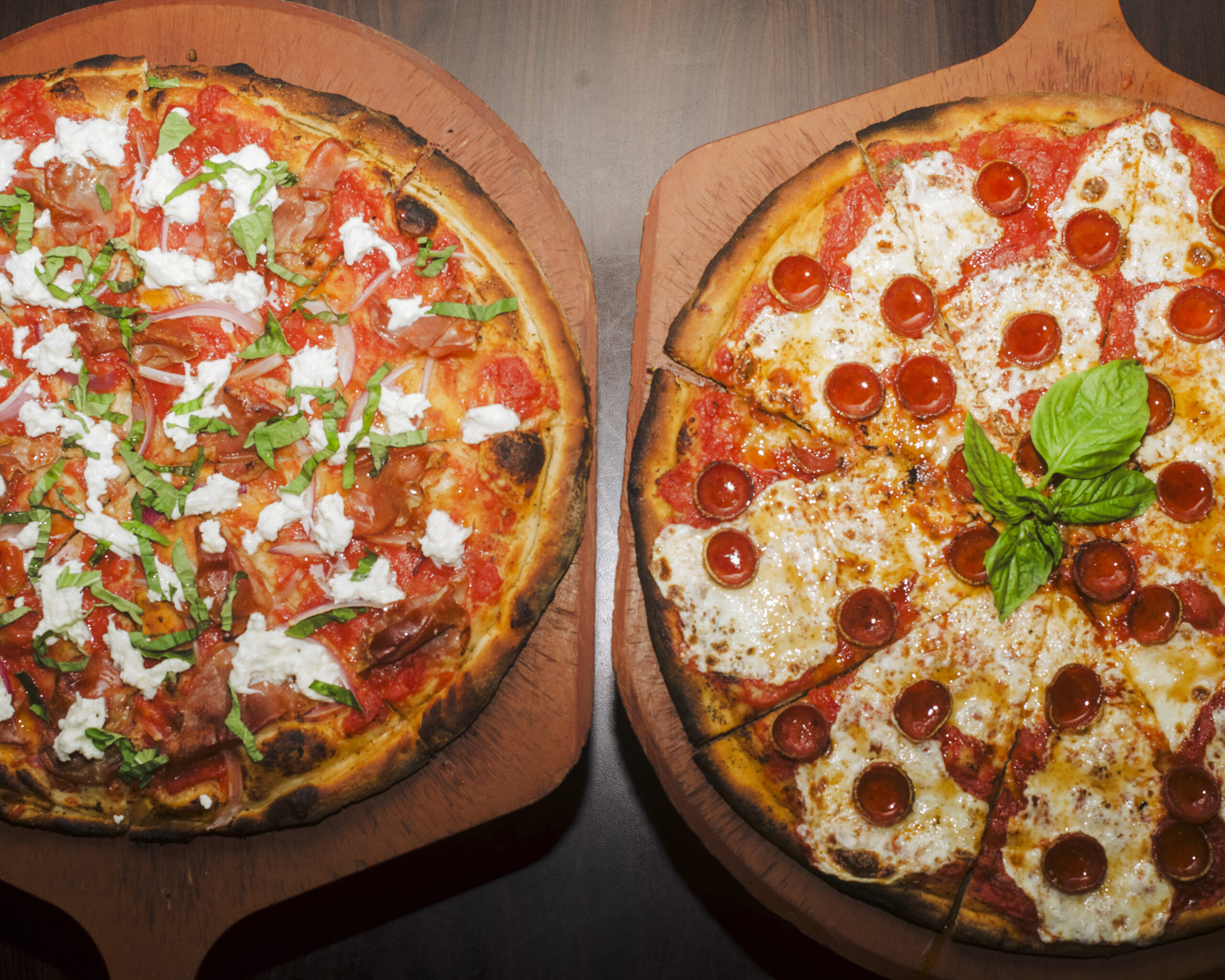 Flat-lay shot of Mike’s Hot Honey Pepperoni Pizza and Mike’s Hot Honey Burrata from Anthony’s.