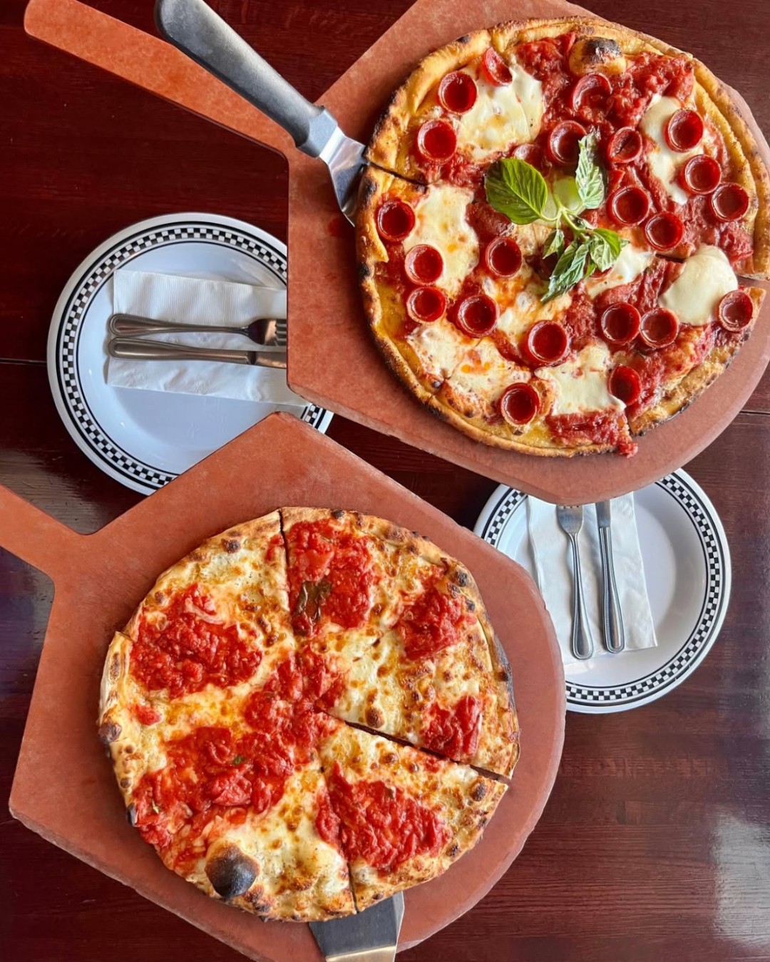 Mike’s Hot Honey Pie drizzled and a classic cheese pie on a coal‑fired crust in Anthony’s chill-lined kitchen setting.