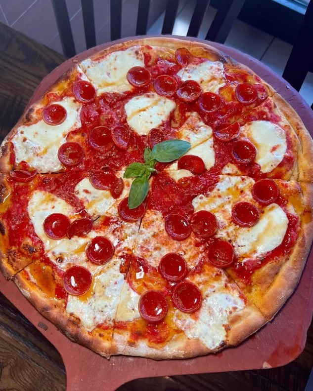 Coal‑fired Mike’s Hot Honey Pizza with glossy honey drizzle and melted cheese at Anthony’s.