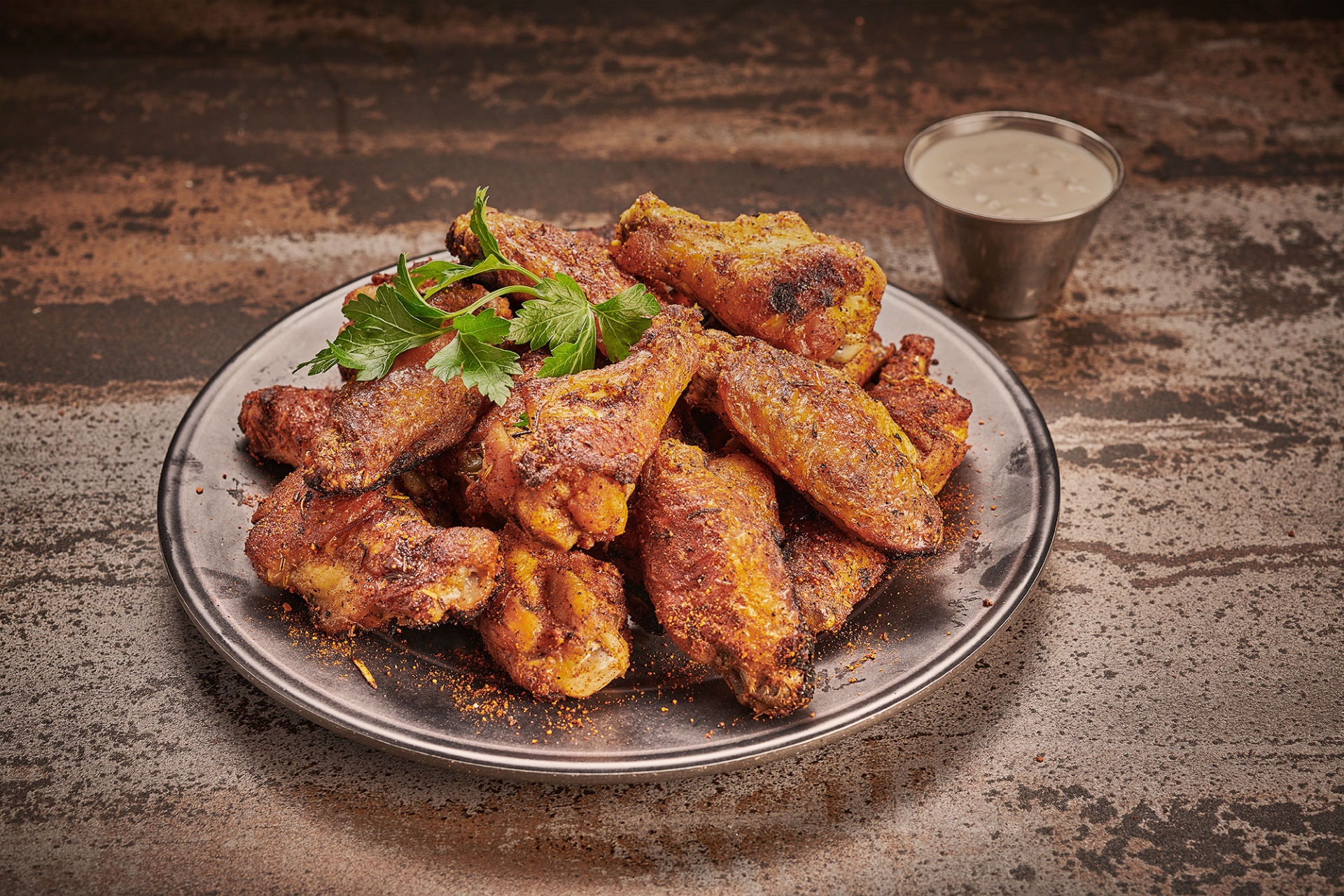 A plate of hot Dry Rub No.2 coated oven-roasted chicken wings from Anthony’s.