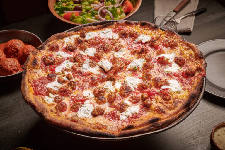 Close-up of Meatballs & Ricotta Pizza from Anthony’s Coal Fired Pizza, featuring a golden crust and generous dollops of creamy ricotta.