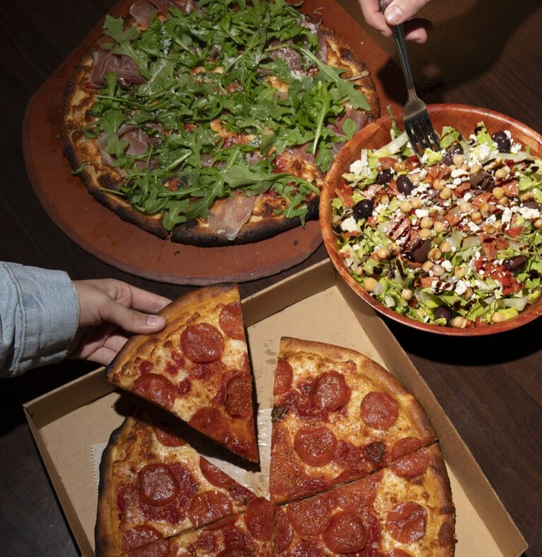 Family-sized feast featuring two coal-fired pizzas and a salad bowl from Anthony’s.